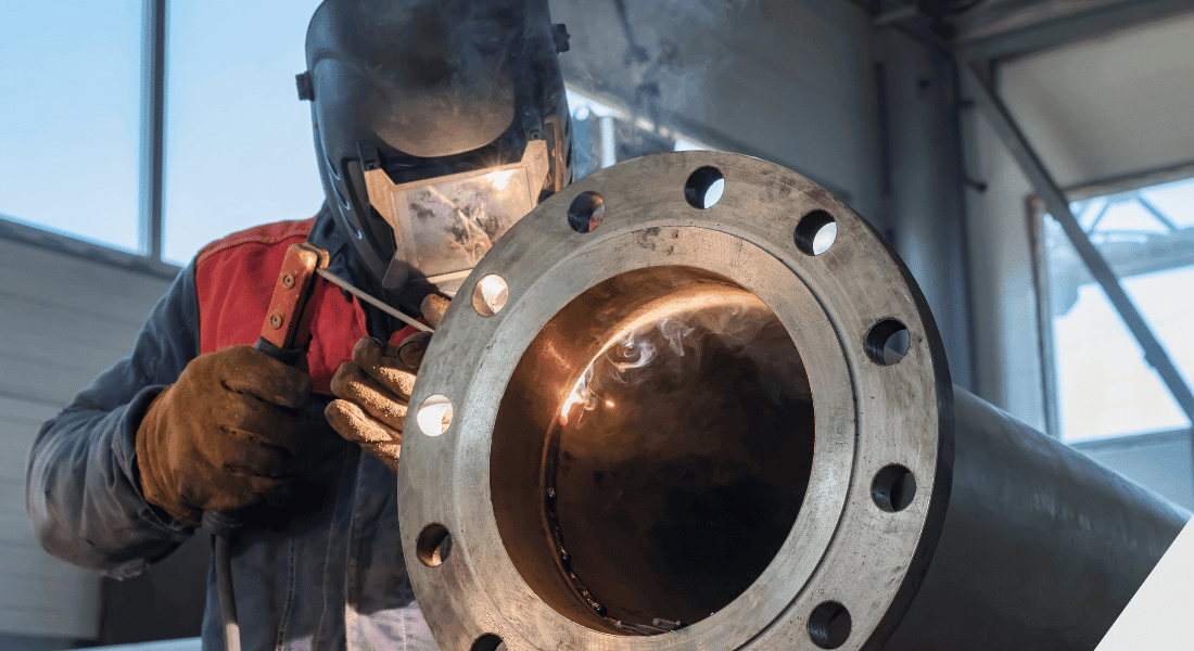 person welding flange on pipe